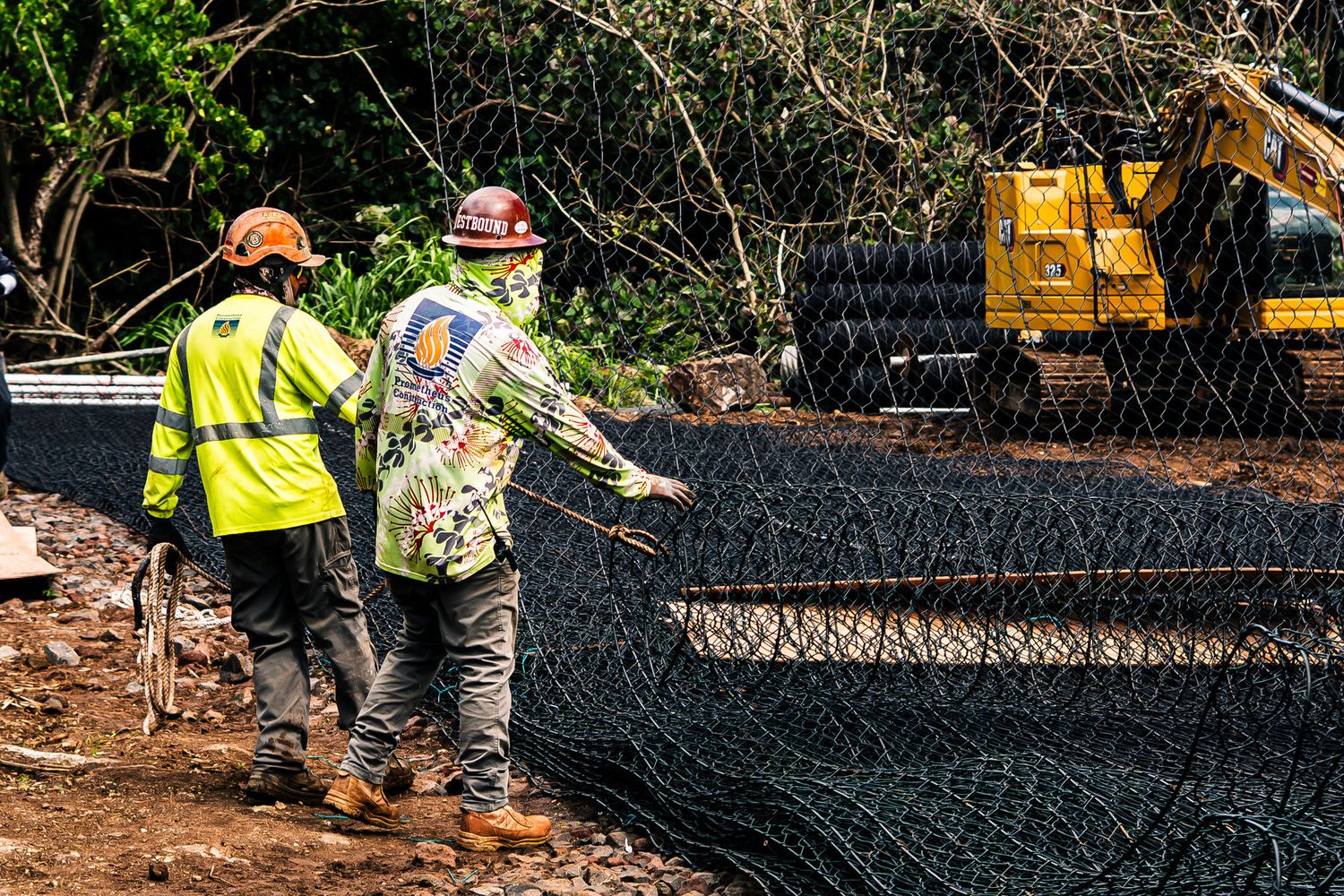 Crew laying slope netting at Waimea Bay