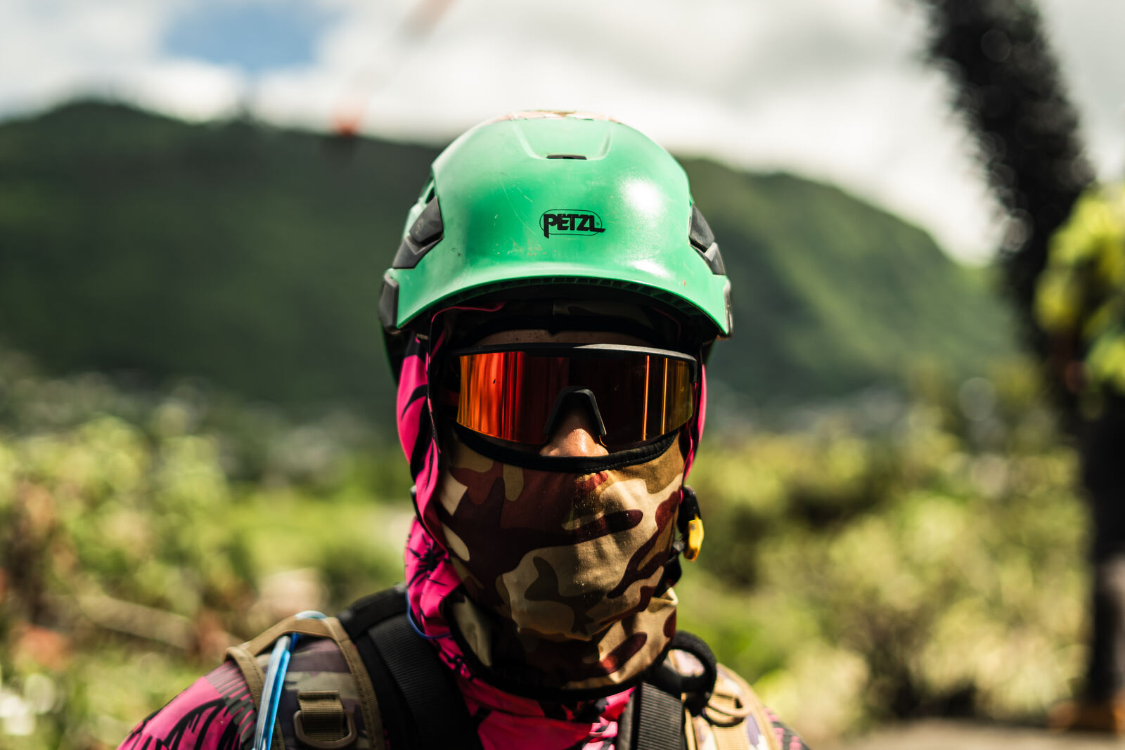 Crew member in a green helmet and mirrored goggles